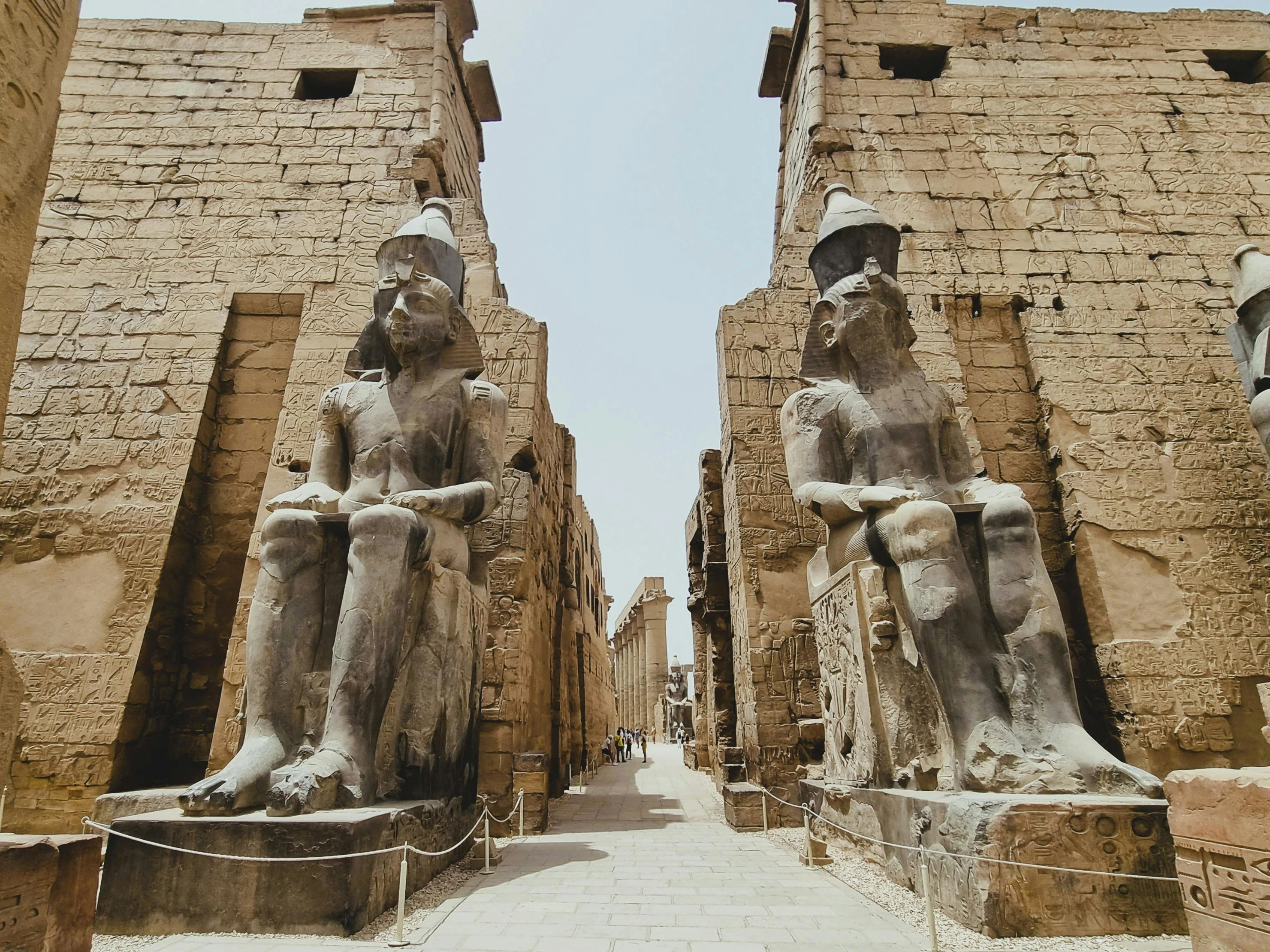 Luxor Temple with grand statues of Ramesses II, showcasing ancient Egyptian architecture